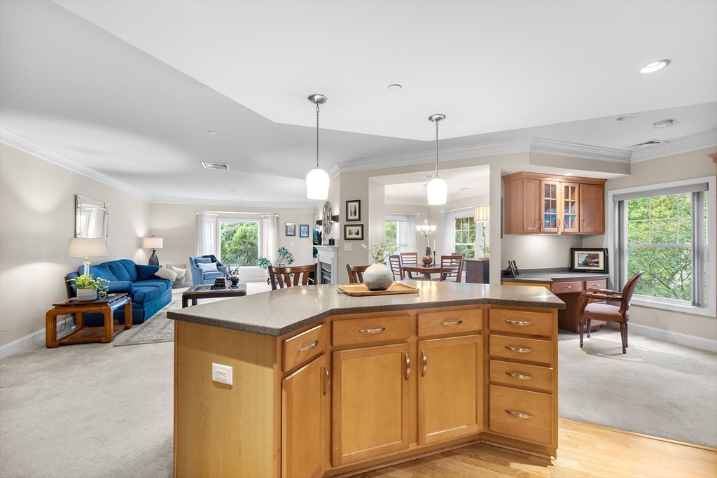 490 Main Street, Unit 215 Northborough, MA 01532 - Photo 14 of 37 a kitchen with sink a counter and chairs
