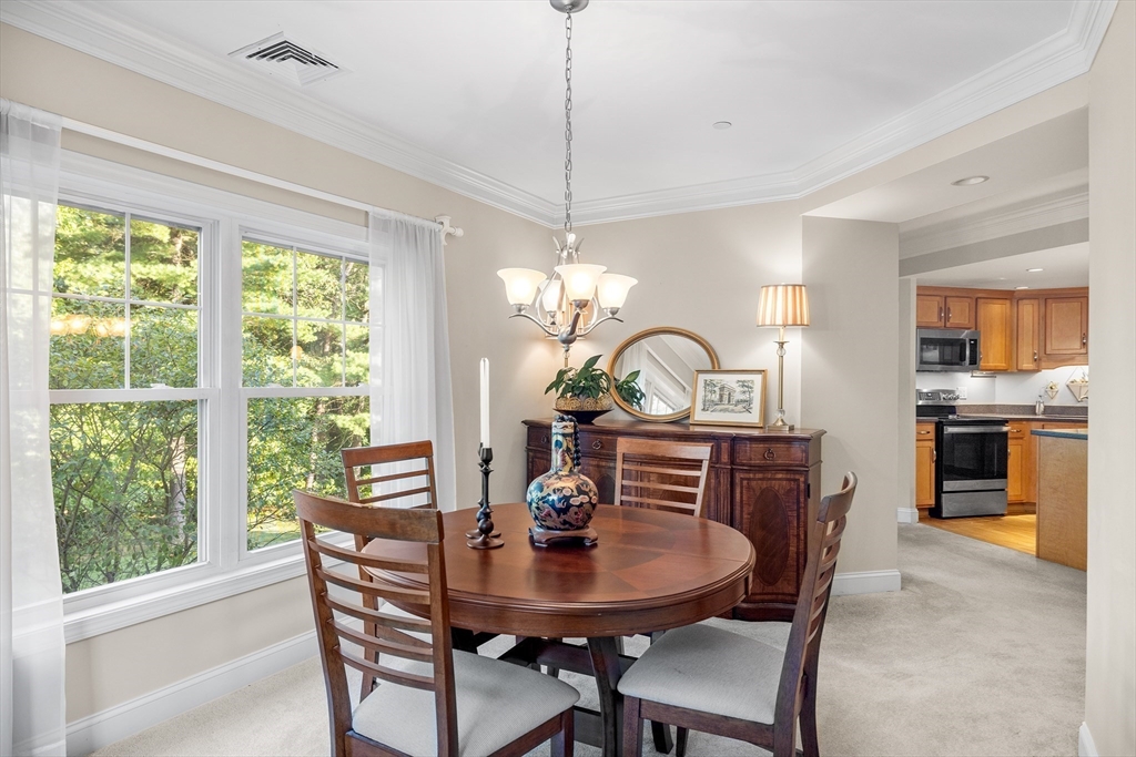 490 Main Street, Unit 215 Northborough, MA 01532 - Photo 17 of 37 a view of a dining room with furniture window and wooden floor
