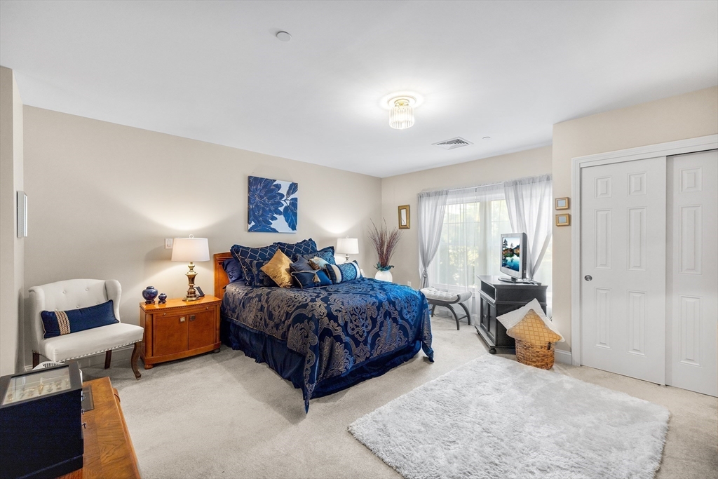490 Main Street, Unit 215 Northborough, MA 01532 - Photo 19 of 37 a bed room with furniture and a window
