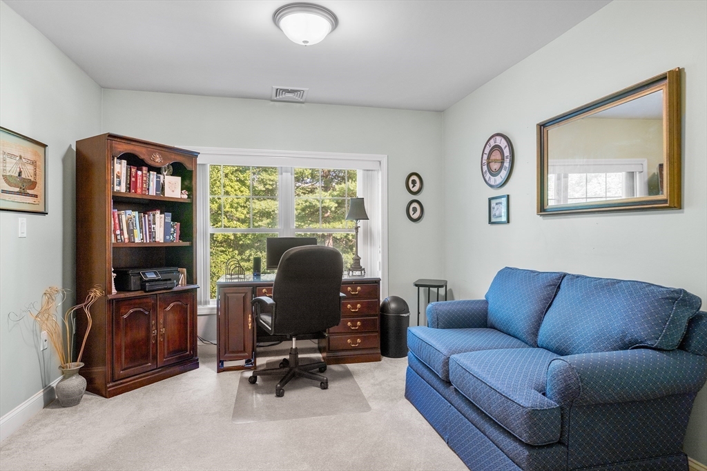 490 Main Street, Unit 215 Northborough, MA 01532 - Photo 25 of 37 a living room with furniture and a flat screen tv