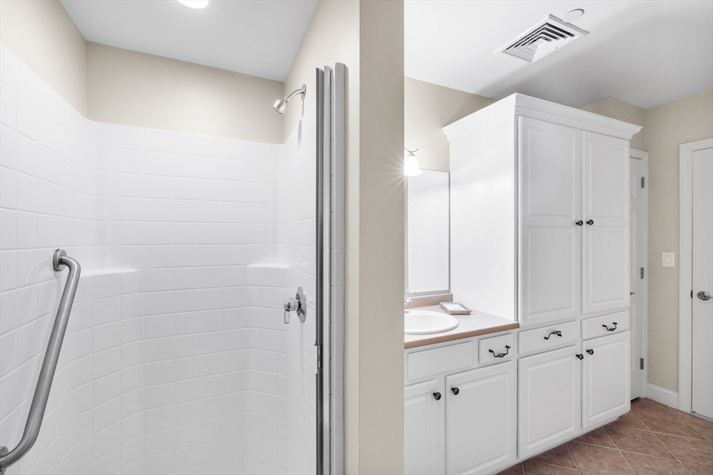 490 Main Street, Unit 215 Northborough, MA 01532 - Photo 29 of 37 a bathroom with a shower and a sink