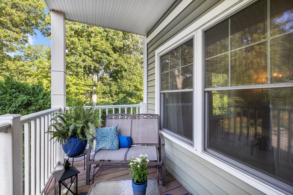 490 Main Street, Unit 215 Northborough, MA 01532 - Photo 31 of 37 a view of a balcony with chair and table