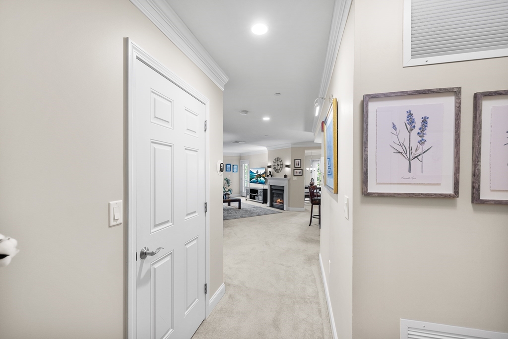 490 Main Street, Unit 215 Northborough, MA 01532 - Photo 7 of 37 a view of a hallway with paintings on the wall
