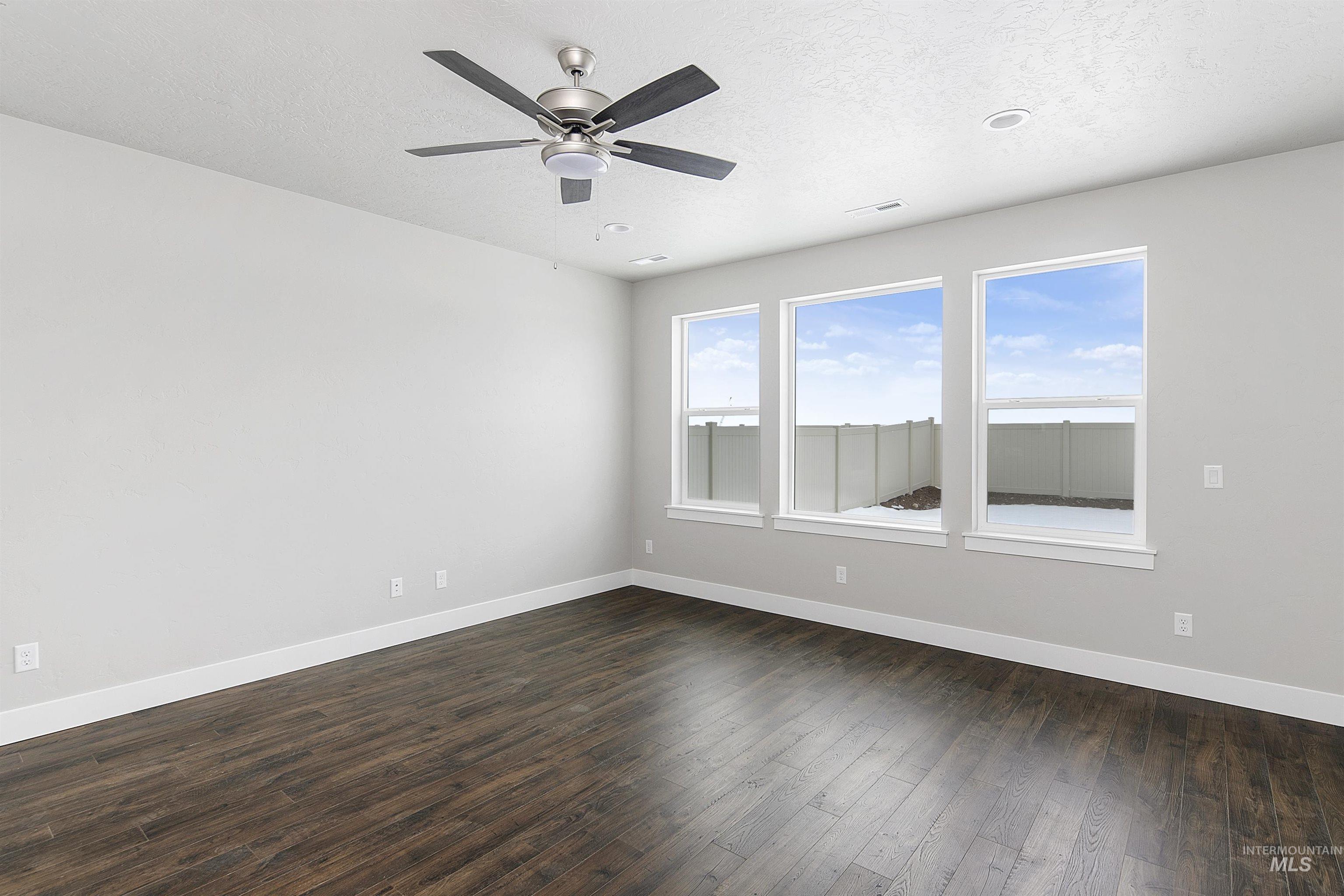 5985 North Backfire Way Meridian, ID 83646 - Photo 17 of 17 Spare room featuring dark wood finished floors, a textured ceiling, and a ceiling fan