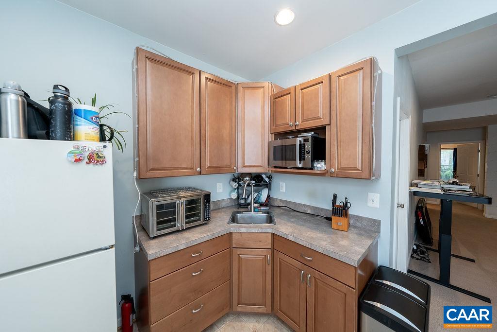 920 Bing Lane Charlottesville, VA 22903 - Photo 19 of 47 a kitchen with stainless steel appliances granite countertop a refrigerator and a sink