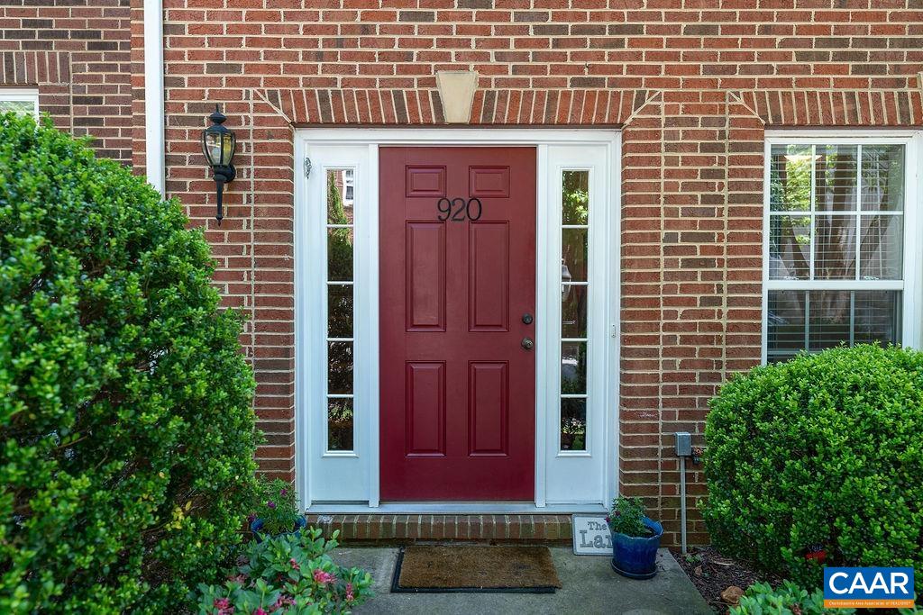 920 Bing Lane Charlottesville, VA 22903 - Photo 6 of 47 a view of a brick house with a red door and a potted plant