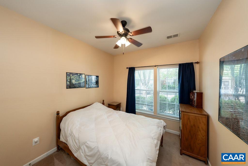 920 Bing Lane Charlottesville, VA 22903 - Photo 8 of 47 a bedroom with a large bed and a chandelier fan
