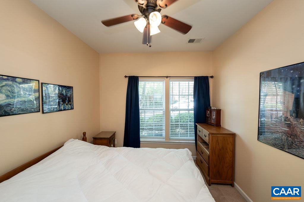 920 Bing Lane Charlottesville, VA 22903 - Photo 9 of 47 a bedroom with a bed and a chandelier fan
