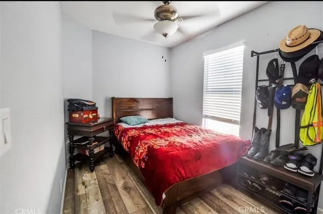 a bedroom with a bed and a flat tv screen on the dresser