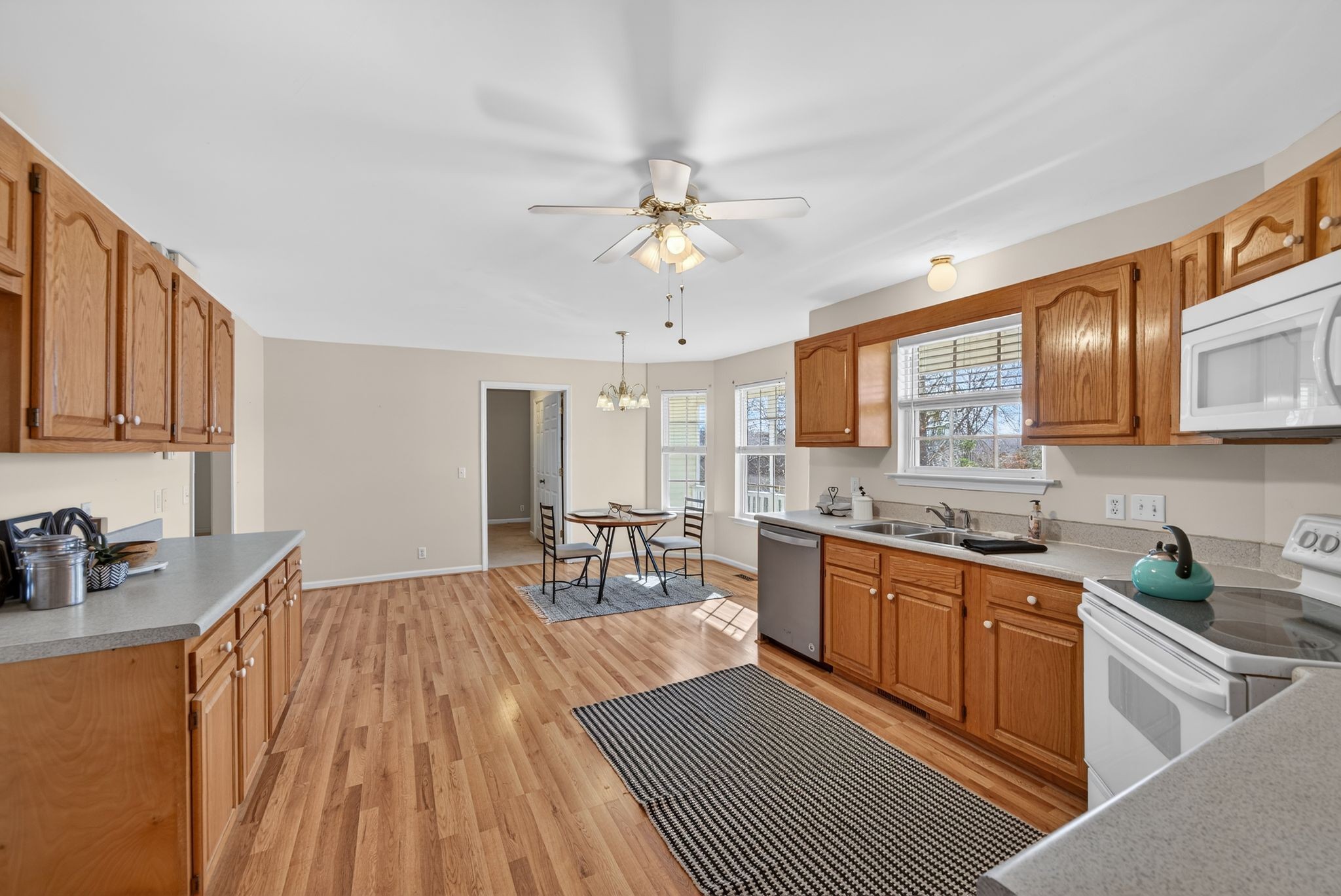 833 Blakemore Road Dickson, TN 37055 - Photo 21 of 47 a kitchen with stainless steel appliances granite countertop a sink dishwasher stove top oven and cabinets with wooden floor