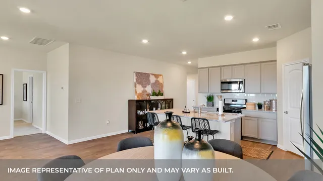 a living room with stainless steel appliances kitchen island granite countertop furniture and a view of kitchen