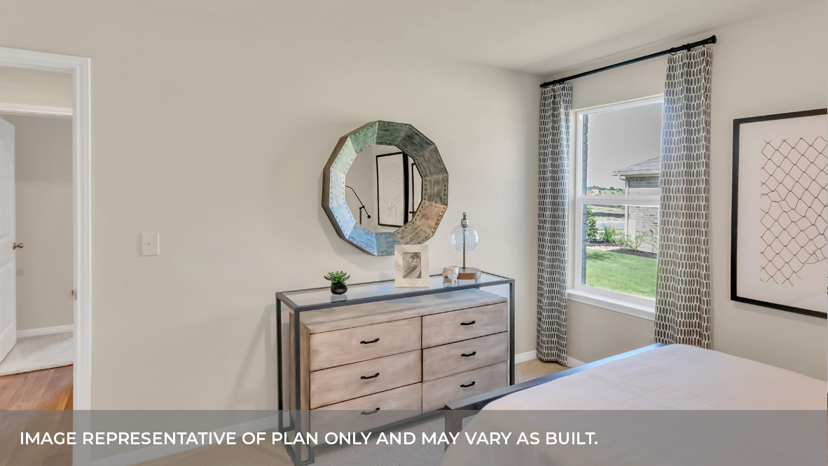 9504 Oxbow Strap Drive Austin, TX 78724 - Photo 9 of 30 a bedroom with a bed a mirror on dresser and a window