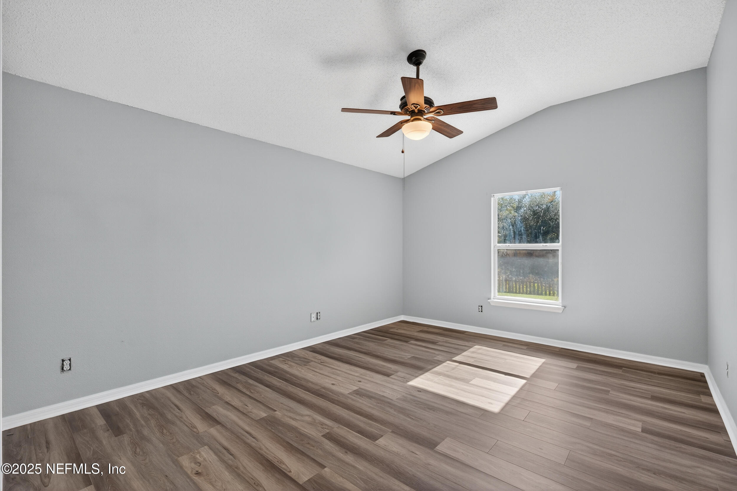 10174 Rising Mist Lane Jacksonville, FL 32221 - Photo 20 of 31 a view of empty room with wooden floor and fan