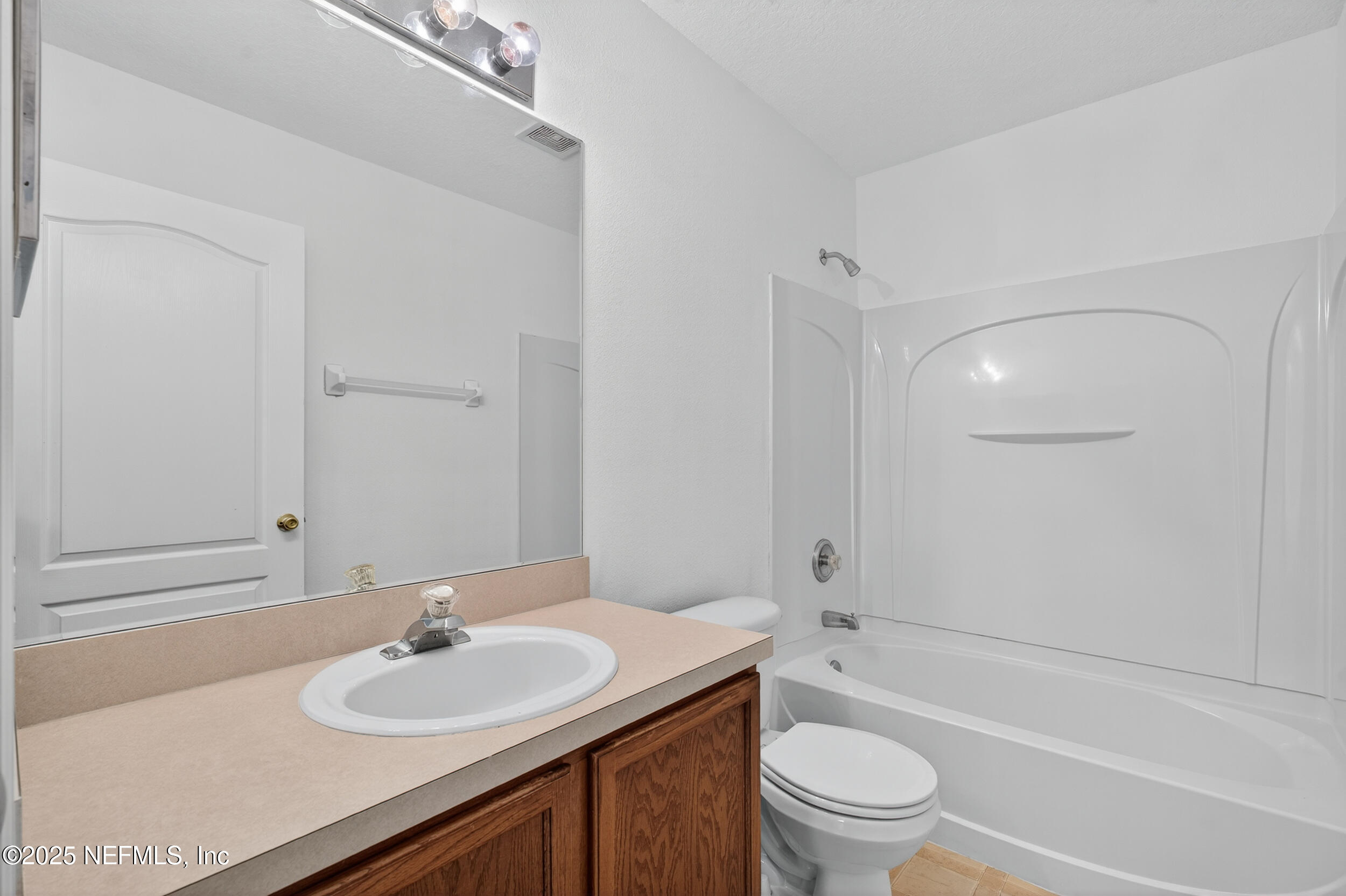 10174 Rising Mist Lane Jacksonville, FL 32221 - Photo 22 of 31 a bathroom with a sink a toilet and shower