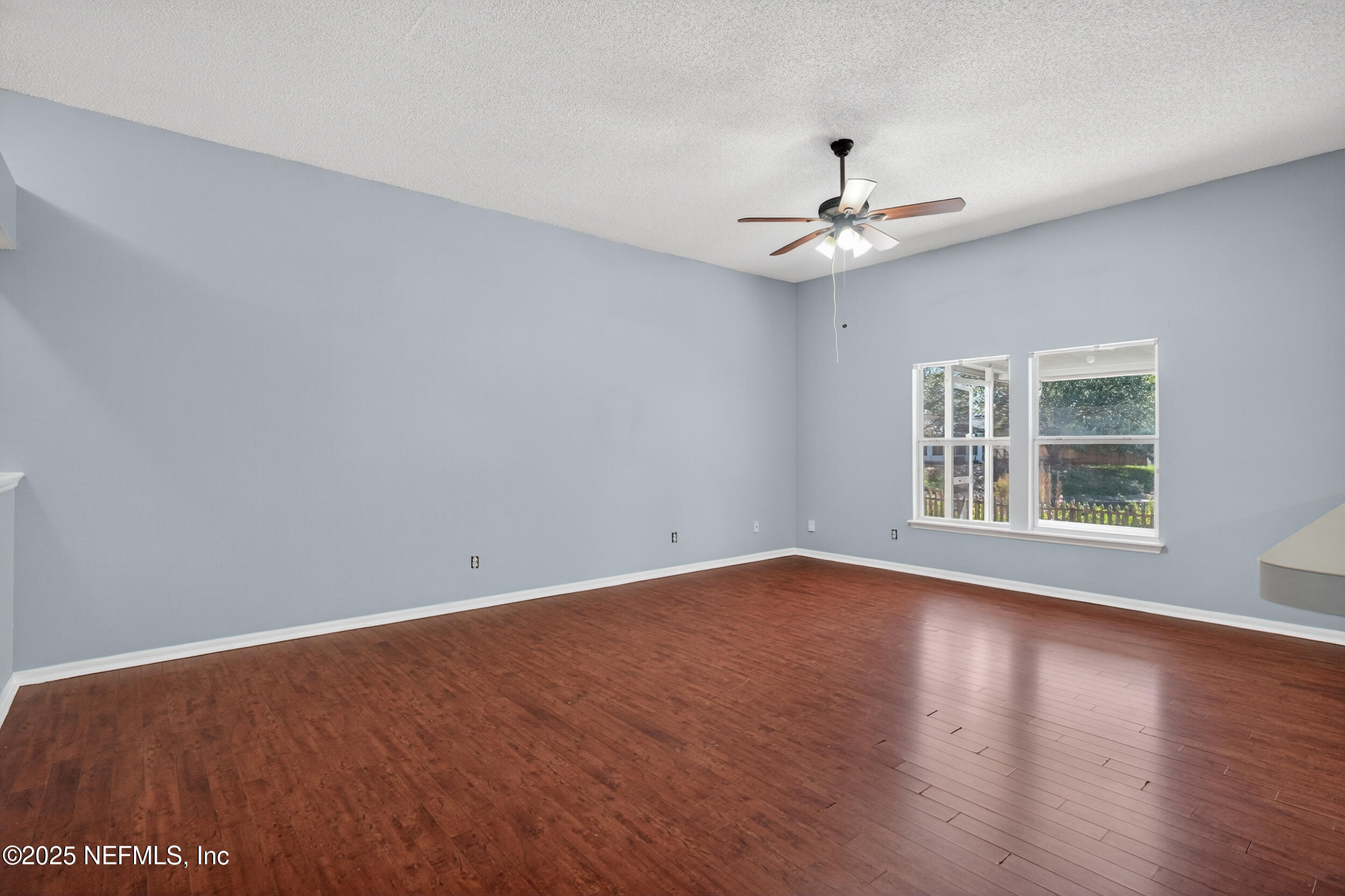 10174 Rising Mist Lane Jacksonville, FL 32221 - Photo 8 of 31 wooden floor in an empty room with a window