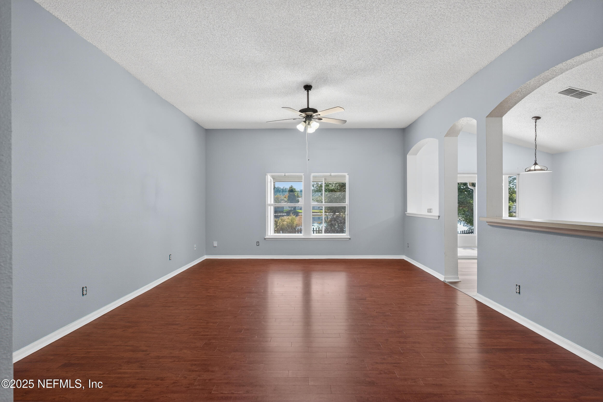 10174 Rising Mist Lane Jacksonville, FL 32221 - Photo 9 of 31 a view of an empty room with a window and wooden floor