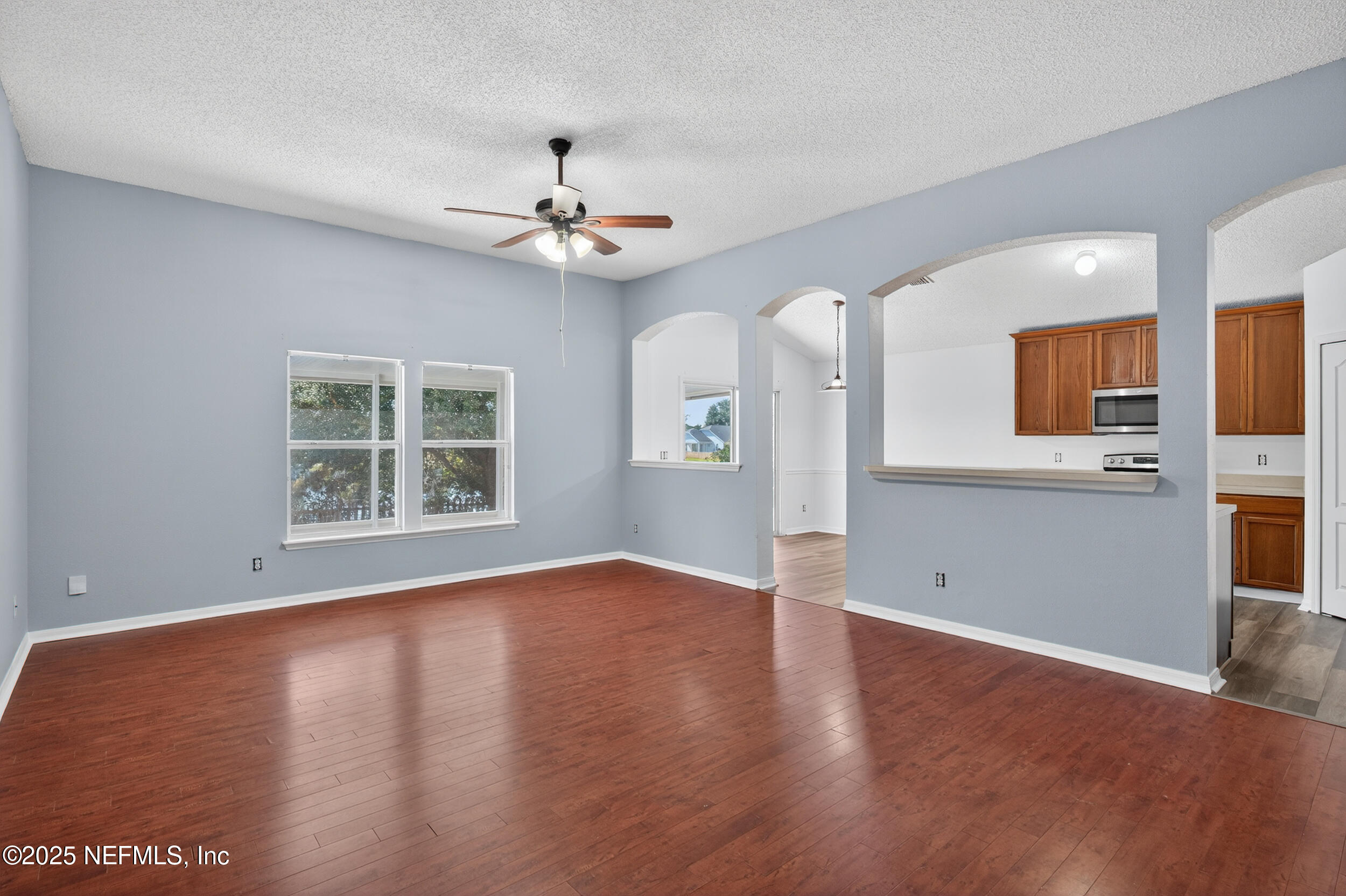 10174 Rising Mist Lane Jacksonville, FL 32221 - Photo 10 of 31 a view of an empty room with a window and wooden floor