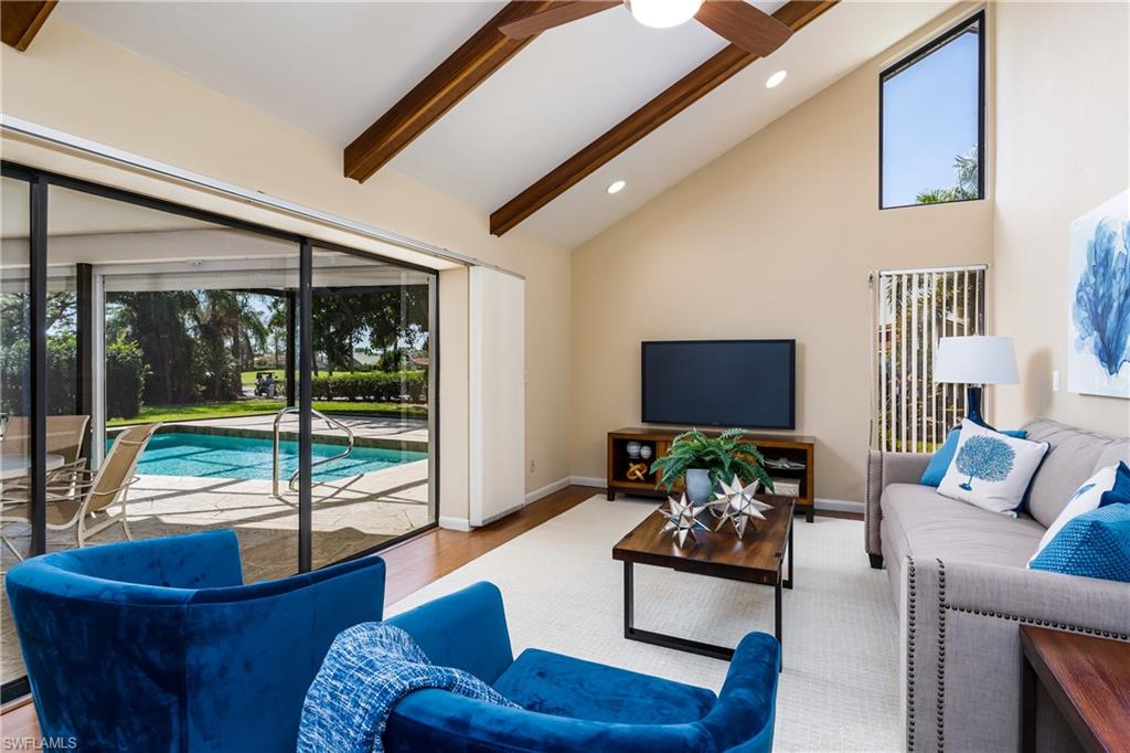 a living room with furniture and a floor to ceiling window
