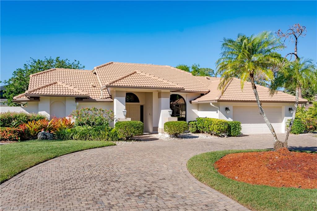 1172 Kings Way Naples, FL 34104 - Photo 11 of 50 a front view of a house with a garden