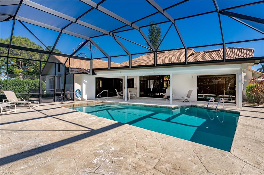 1172 Kings Way Naples, FL 34104 - Photo 14 of 50 a view of a backyard with table and chairs under an umbrella