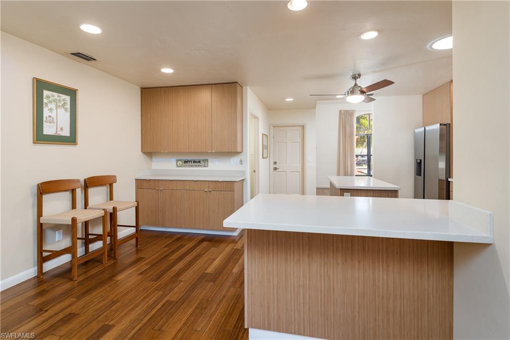 1172 Kings Way Naples, FL 34104 - Photo 21 of 50 a kitchen with kitchen island a counter top space a sink stainless steel appliances and cabinets