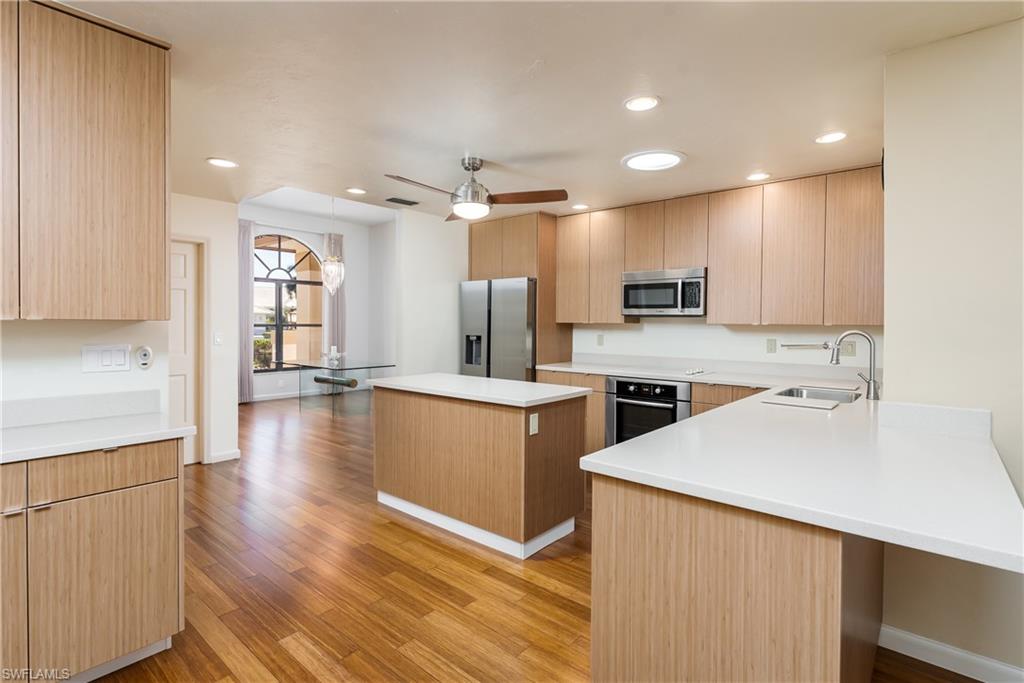 1172 Kings Way Naples, FL 34104 - Photo 24 of 50 a kitchen with stainless steel appliances kitchen island granite countertop a stove a sink and a refrigerator