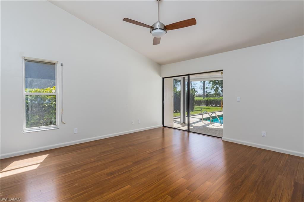 1172 Kings Way Naples, FL 34104 - Photo 26 of 50 a view of an empty room with wooden floor and a window