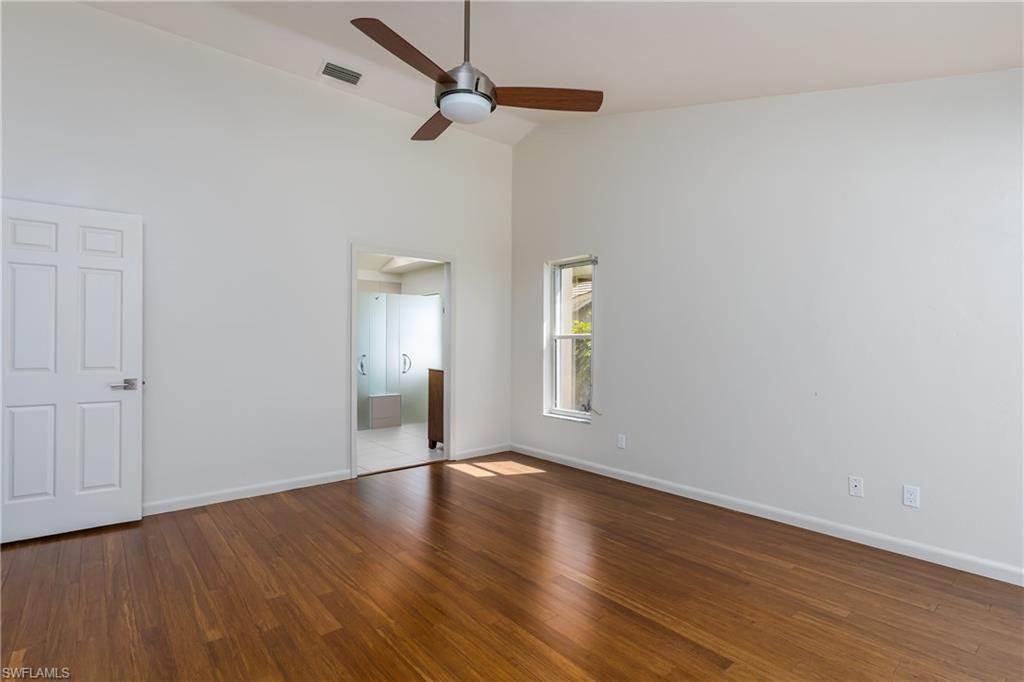 1172 Kings Way Naples, FL 34104 - Photo 28 of 50 a view of an empty room with wooden floor and a window