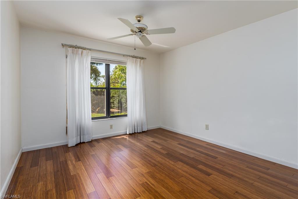 1172 Kings Way Naples, FL 34104 - Photo 32 of 50 a view of an empty room with wooden floor and a window