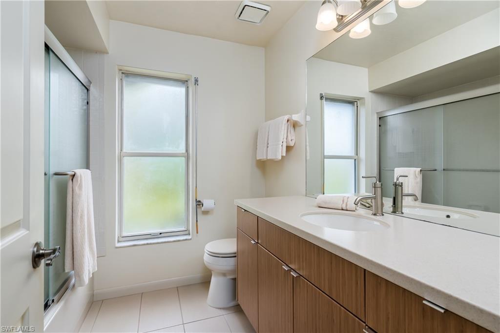 1172 Kings Way Naples, FL 34104 - Photo 35 of 50 a bathroom with a granite countertop sink toilet and mirror