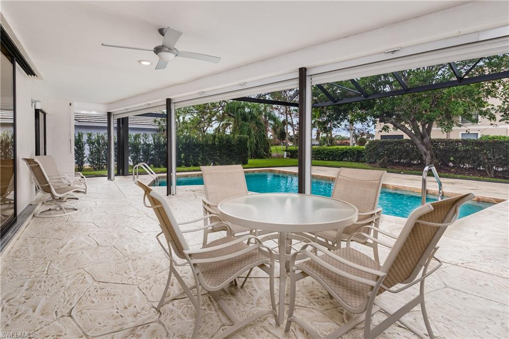 1172 Kings Way Naples, FL 34104 - Photo 44 of 50 a view of a patio with a table chairs and a small yard