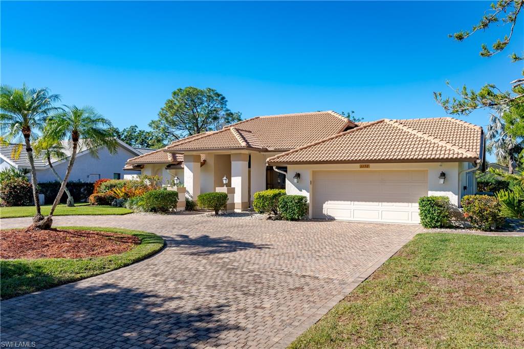 1172 Kings Way Naples, FL 34104 - Photo 46 of 50 a front view of a house with a yard and a garage