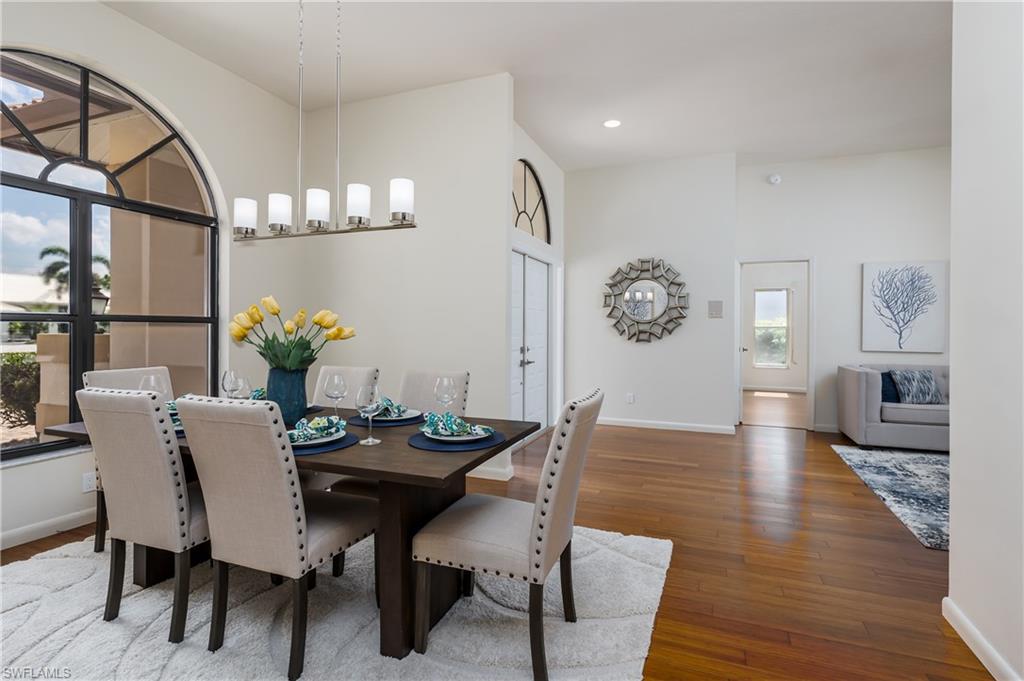 1172 Kings Way Naples, FL 34104 - Photo 5 of 50 a view of a dining room with furniture and wooden floor