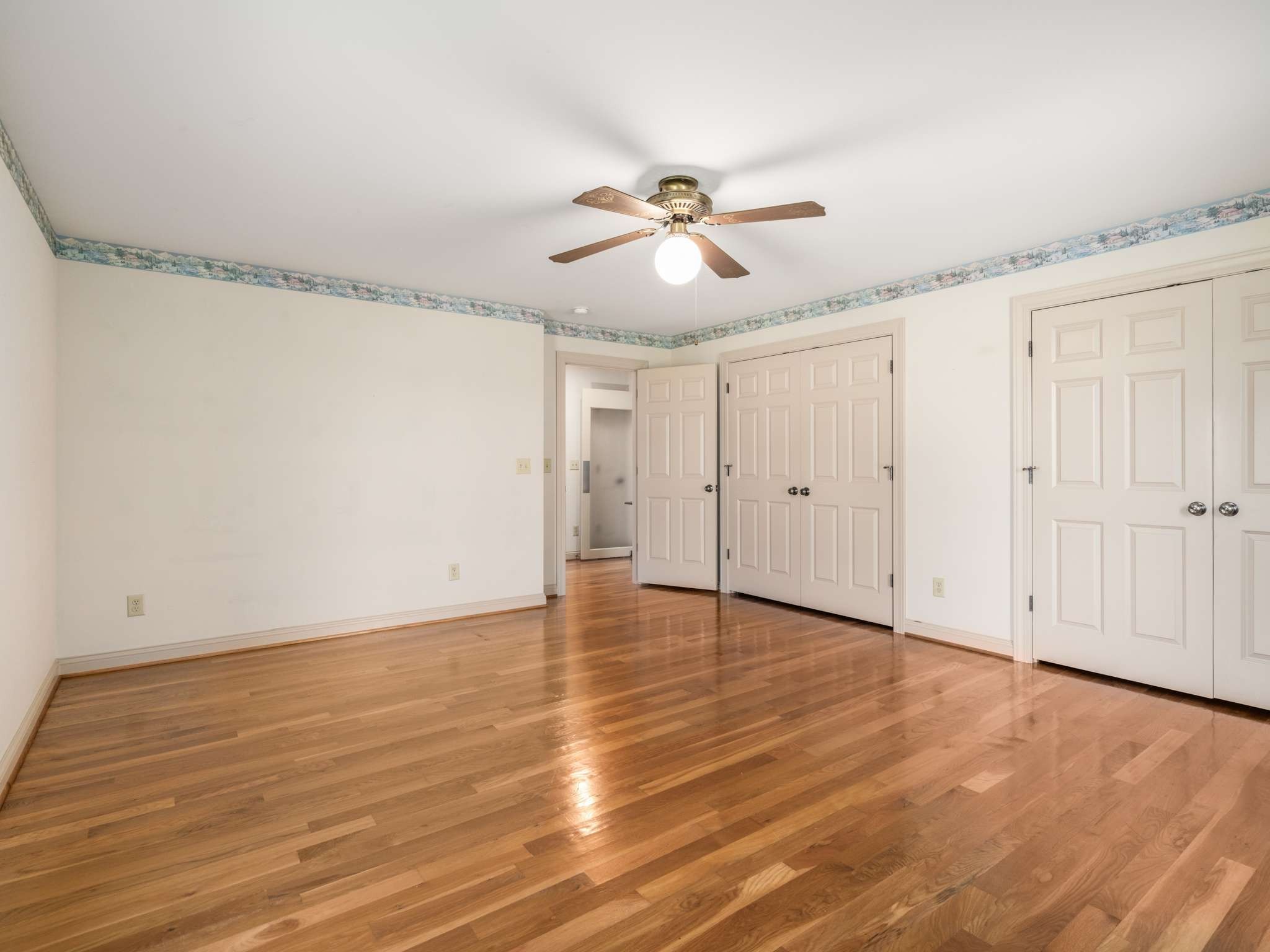 2840 Thomas Road Nolensville, TN 37135 - Photo 28 of 49 an empty room with wooden floor ceiling fan and windows
