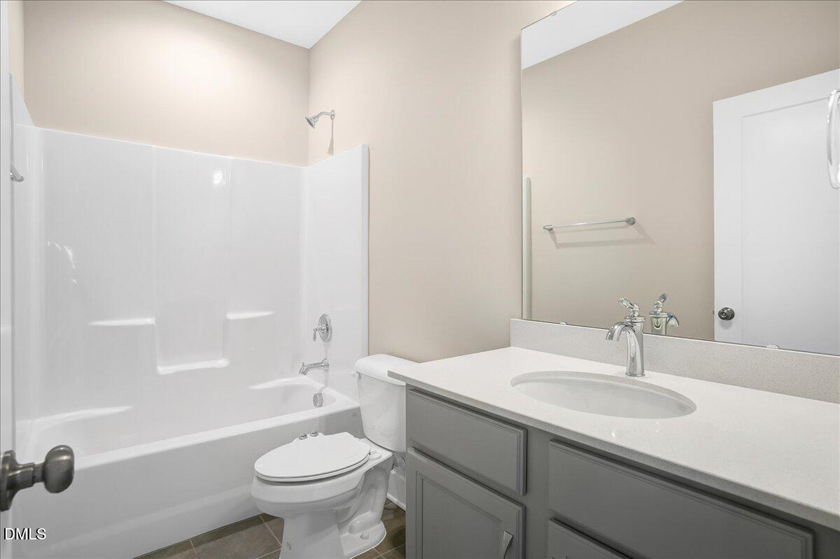 1105 Logperch Way Wendell, NC 27591 - Photo 21 of 29 a bathroom with a sink a toilet and shower