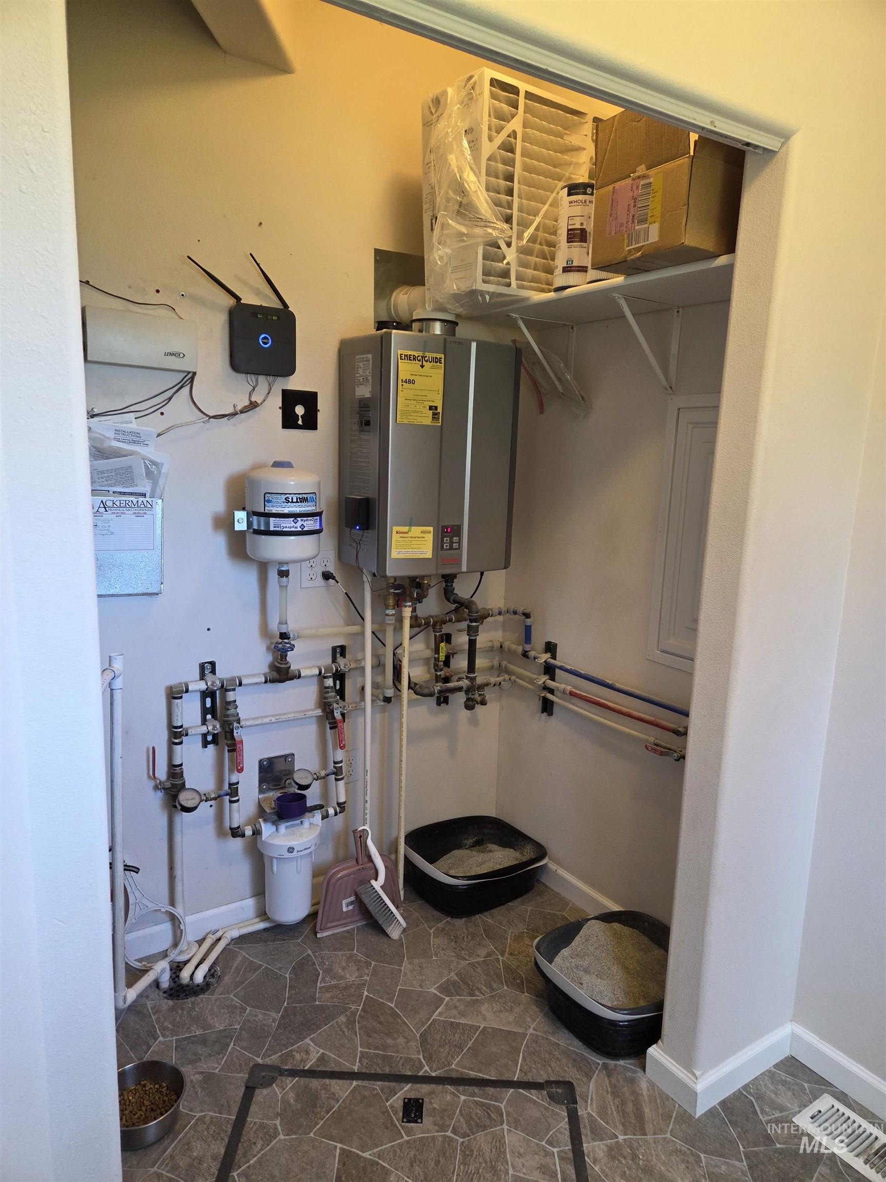 1085 Wallen Road Moscow, ID 83843 - Photo 30 of 50 Utility closet with tankless water heater, water filtration system, and PEX plumbing manifold
