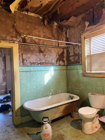 a bathroom with a toilet a sink and a mirror