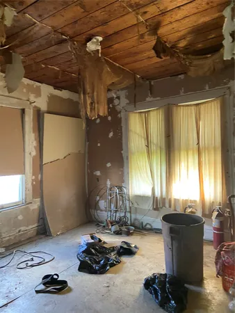 a room with gym equipment and a large window