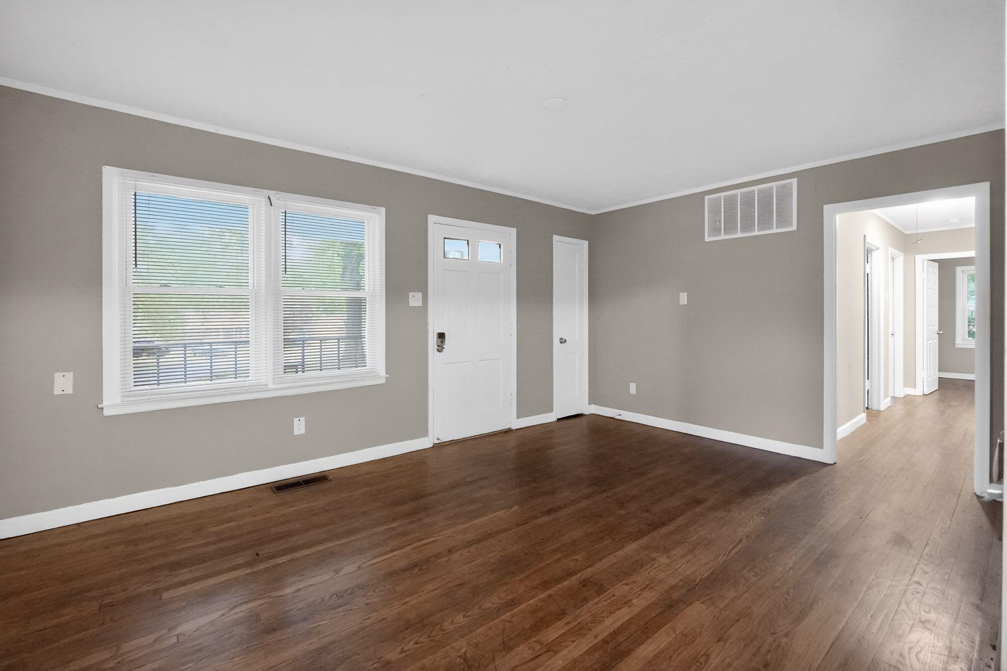 4067 Grantham Road Memphis, TN 38109 - Photo 13 of 34 Entrance foyer with dark wood-style floors, plenty of natural light, and crown molding