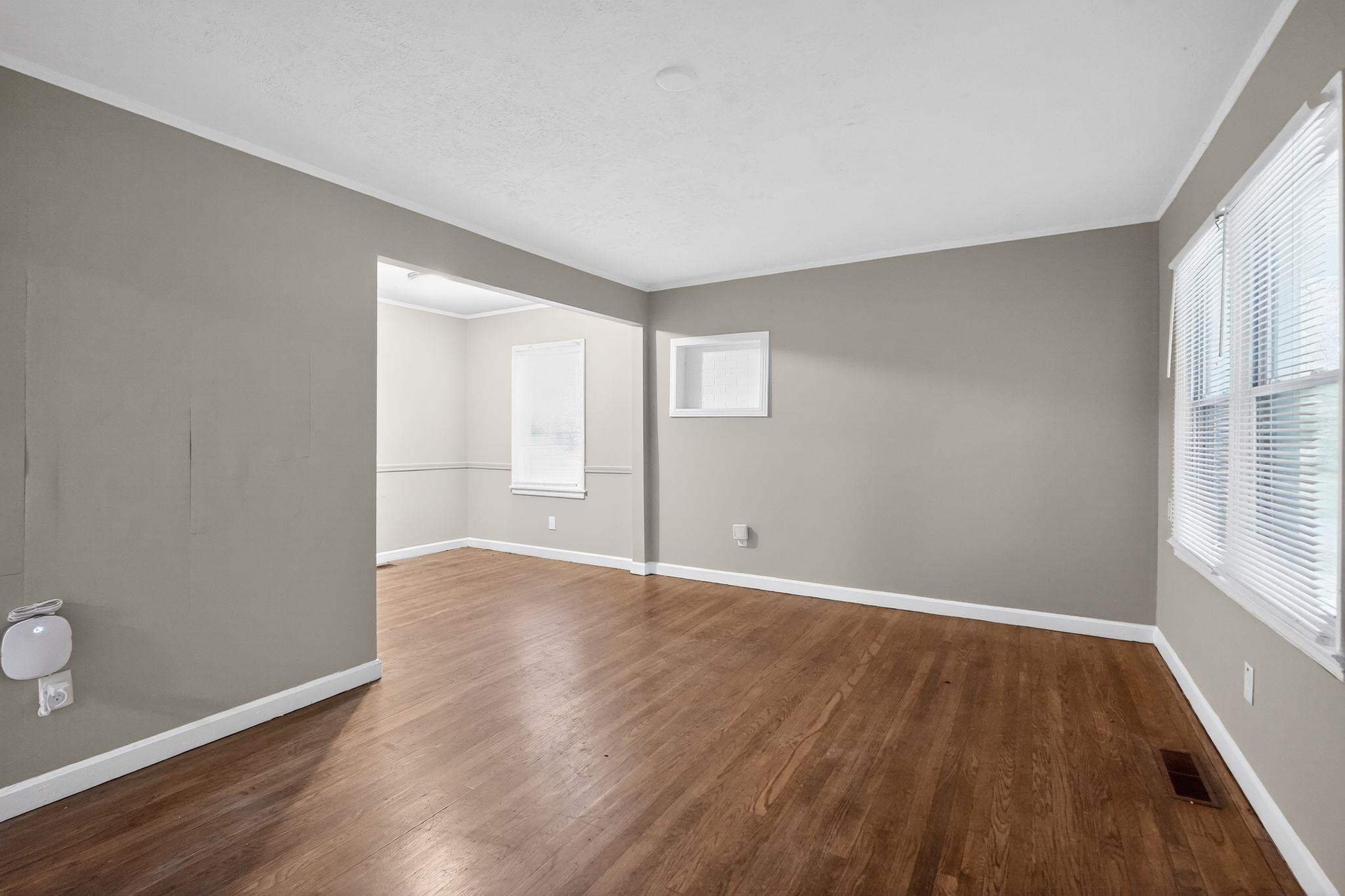 4067 Grantham Road Memphis, TN 38109 - Photo 17 of 34 Spare room with dark wood-type flooring, ornamental molding, and plenty of natural light