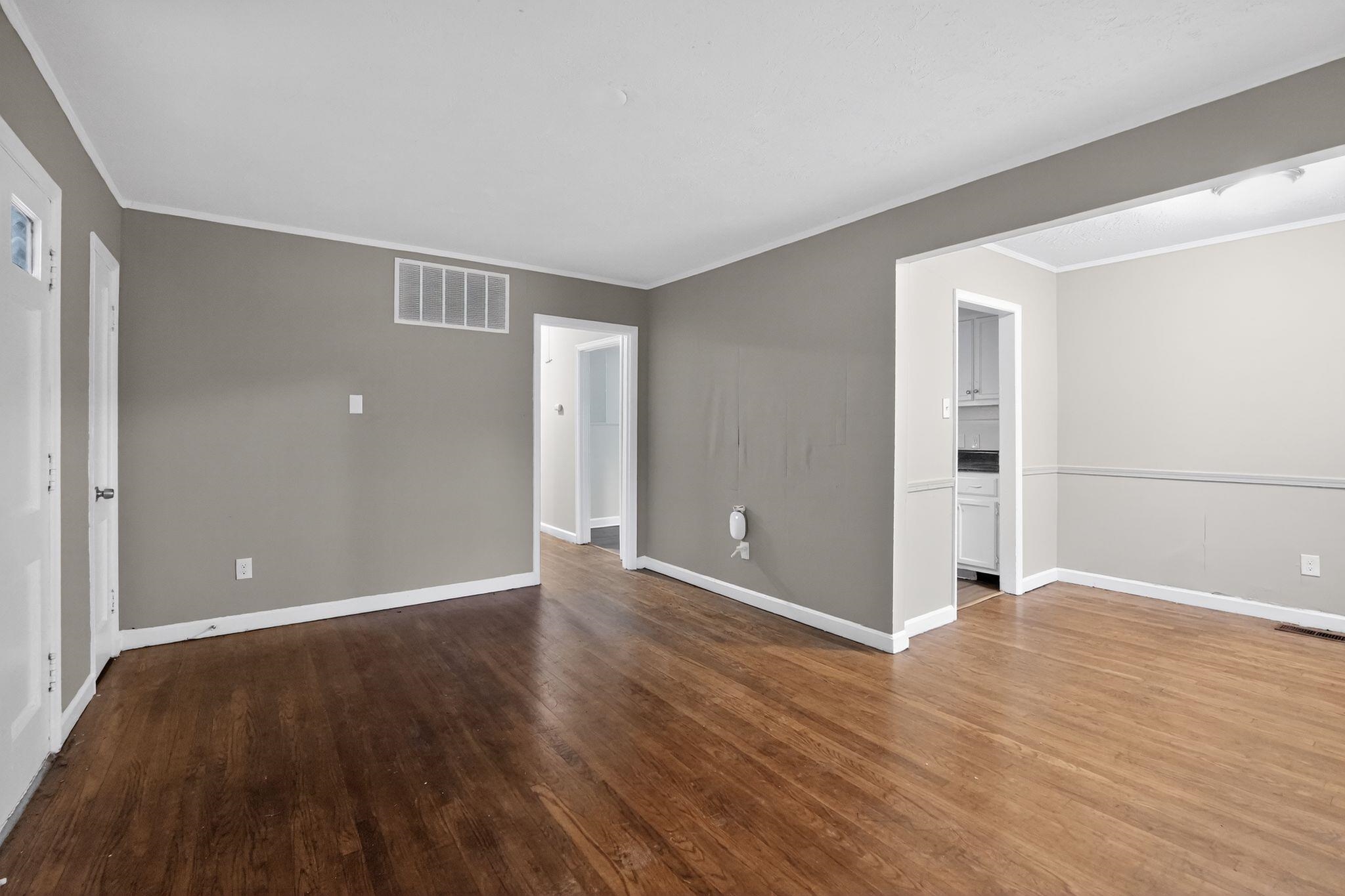 4067 Grantham Road Memphis, TN 38109 - Photo 20 of 34 Empty room featuring dark wood-type flooring and crown molding