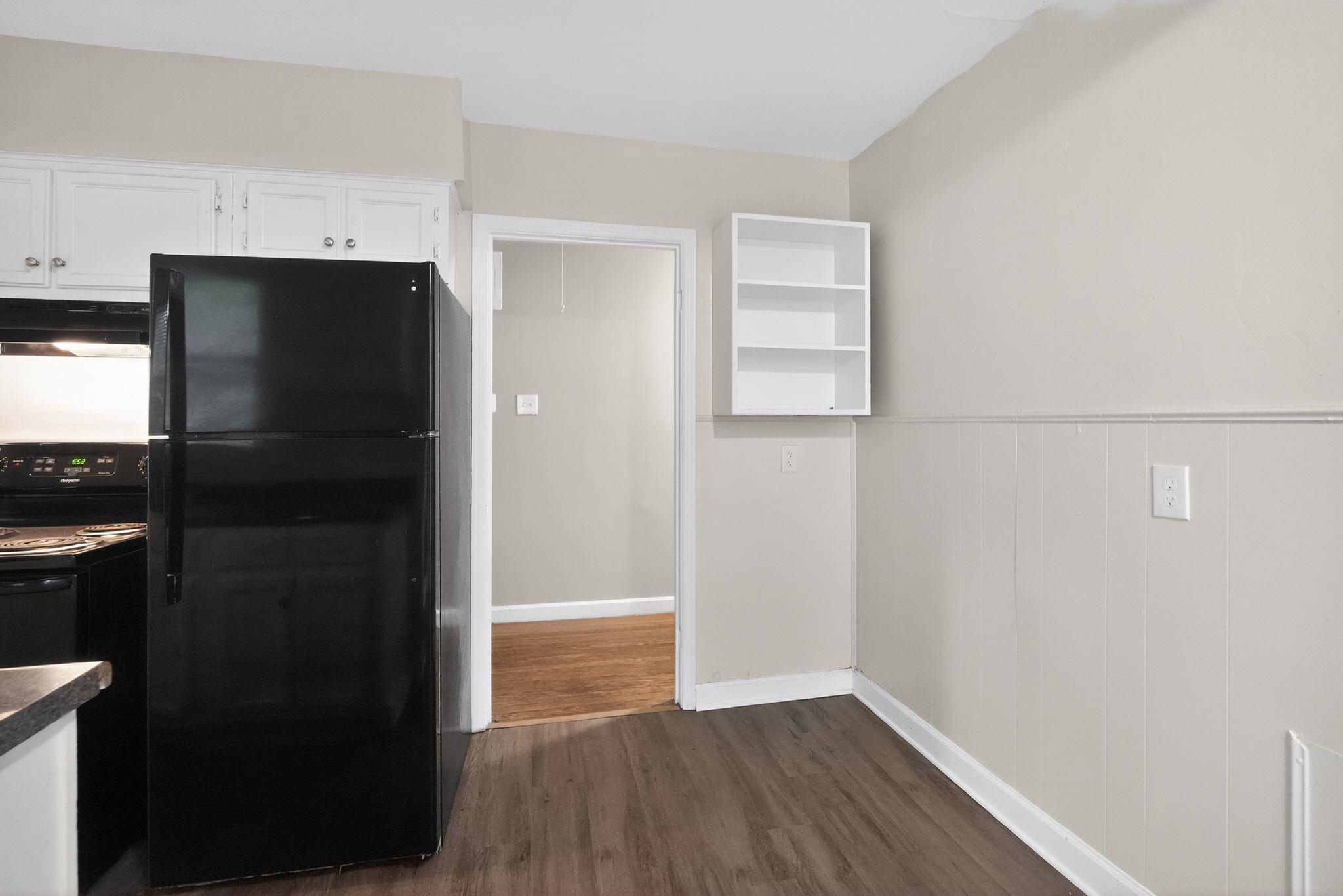 4067 Grantham Road Memphis, TN 38109 - Photo 24 of 34 Kitchen featuring black appliances, open shelves, white cabinetry, and dark wood-style floors