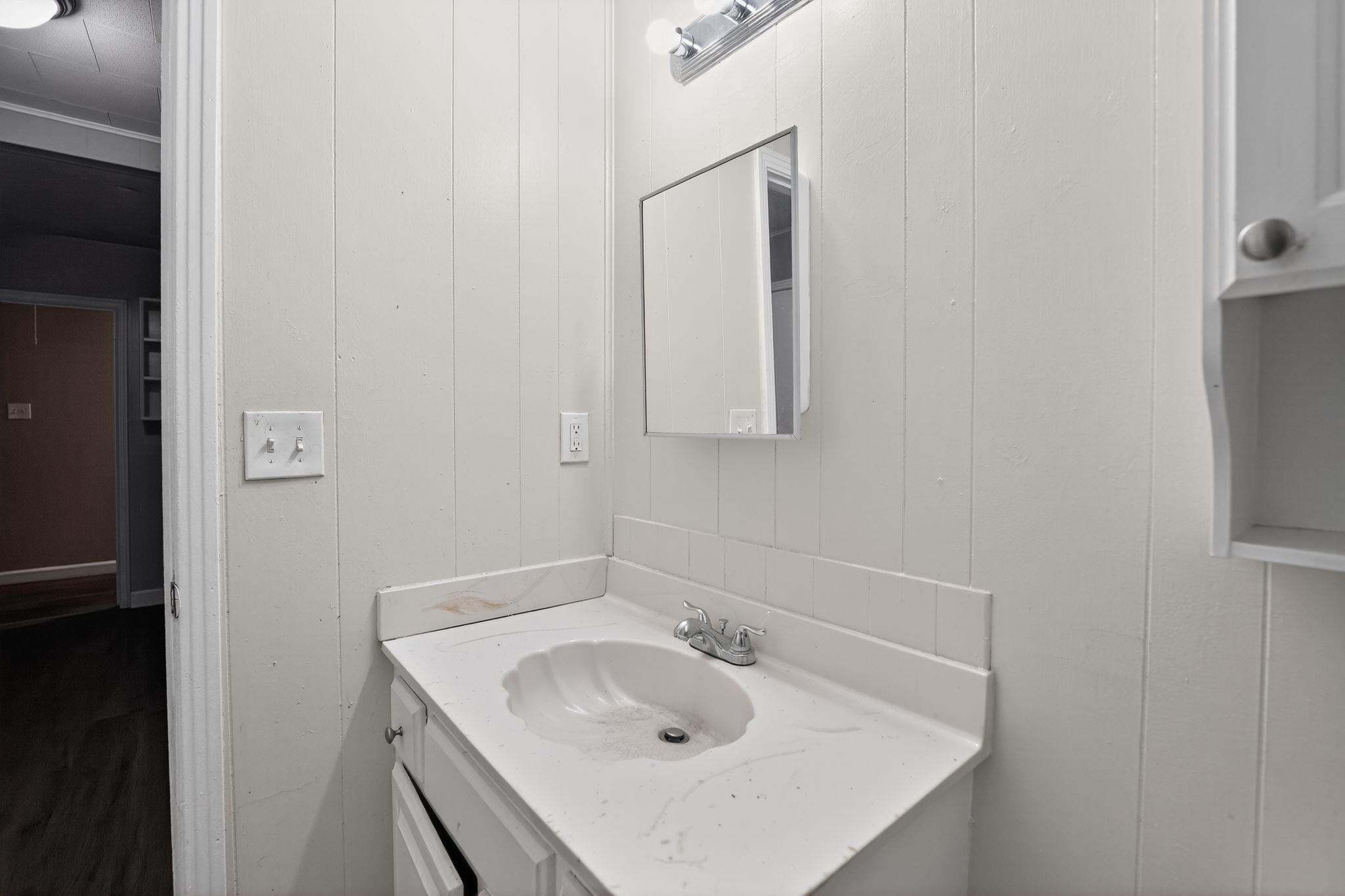 4067 Grantham Road Memphis, TN 38109 - Photo 29 of 34 Bathroom with vanity and wood walls