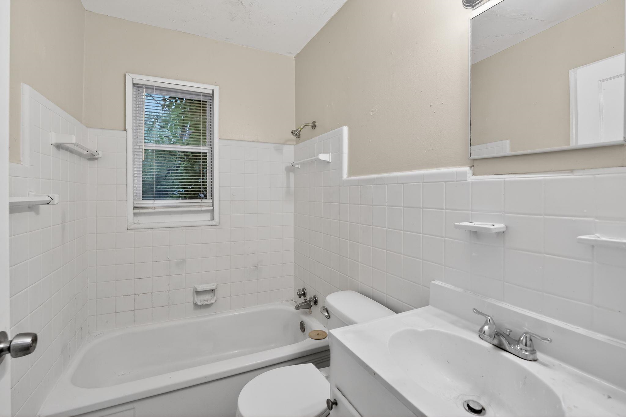 4067 Grantham Road Memphis, TN 38109 - Photo 30 of 34 Bathroom with vanity, shower / tub combination, wainscoting, and tile walls
