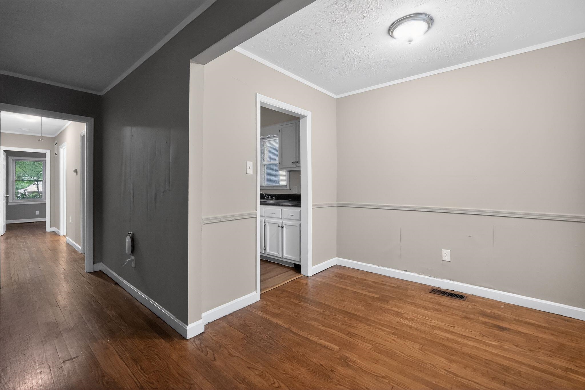 4067 Grantham Road Memphis, TN 38109 - Photo 33 of 34 Hall with ornamental molding, dark wood finished floors, and a textured ceiling