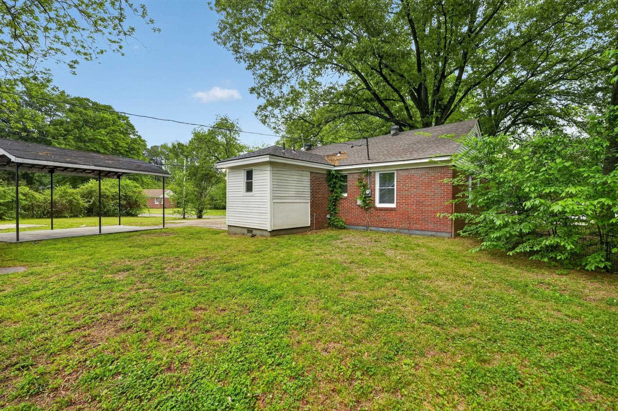 4067 Grantham Road Memphis, TN 38109 - Photo 6 of 34 Rear view of property with a yard and brick siding