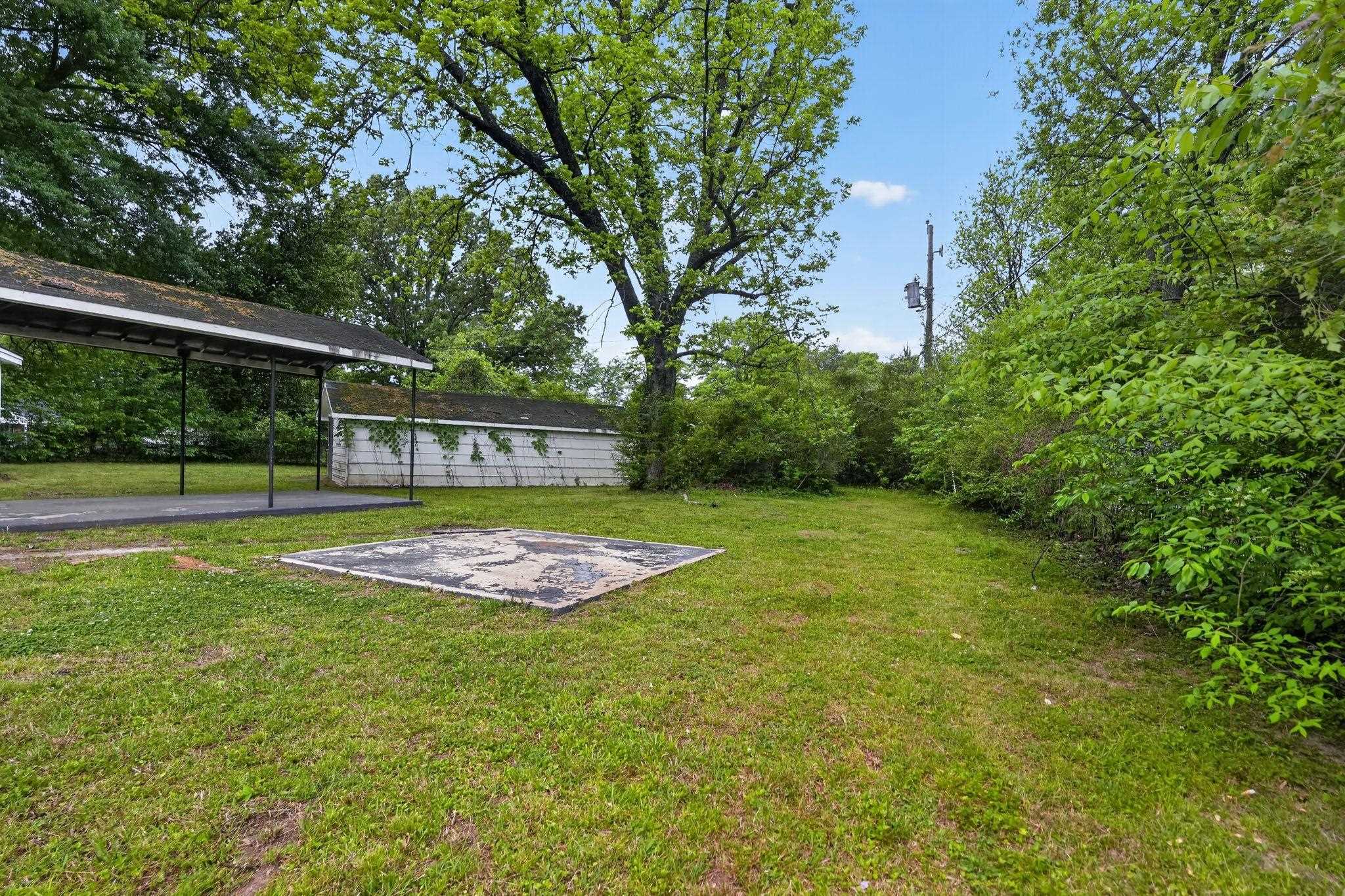 4067 Grantham Road Memphis, TN 38109 - Photo 10 of 34 View of grassy yard with a patio area