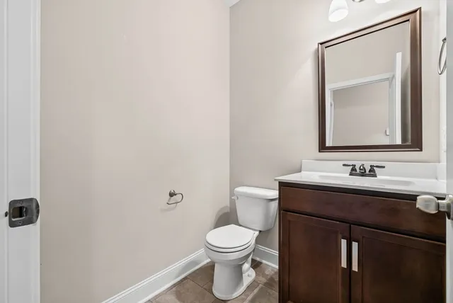a bathroom with a toilet a sink and mirror