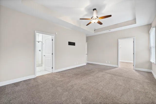 a view of an empty room with a ceiling fan