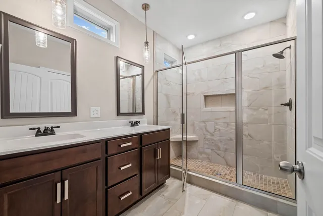 a bathroom with a double vanity sink mirror and double